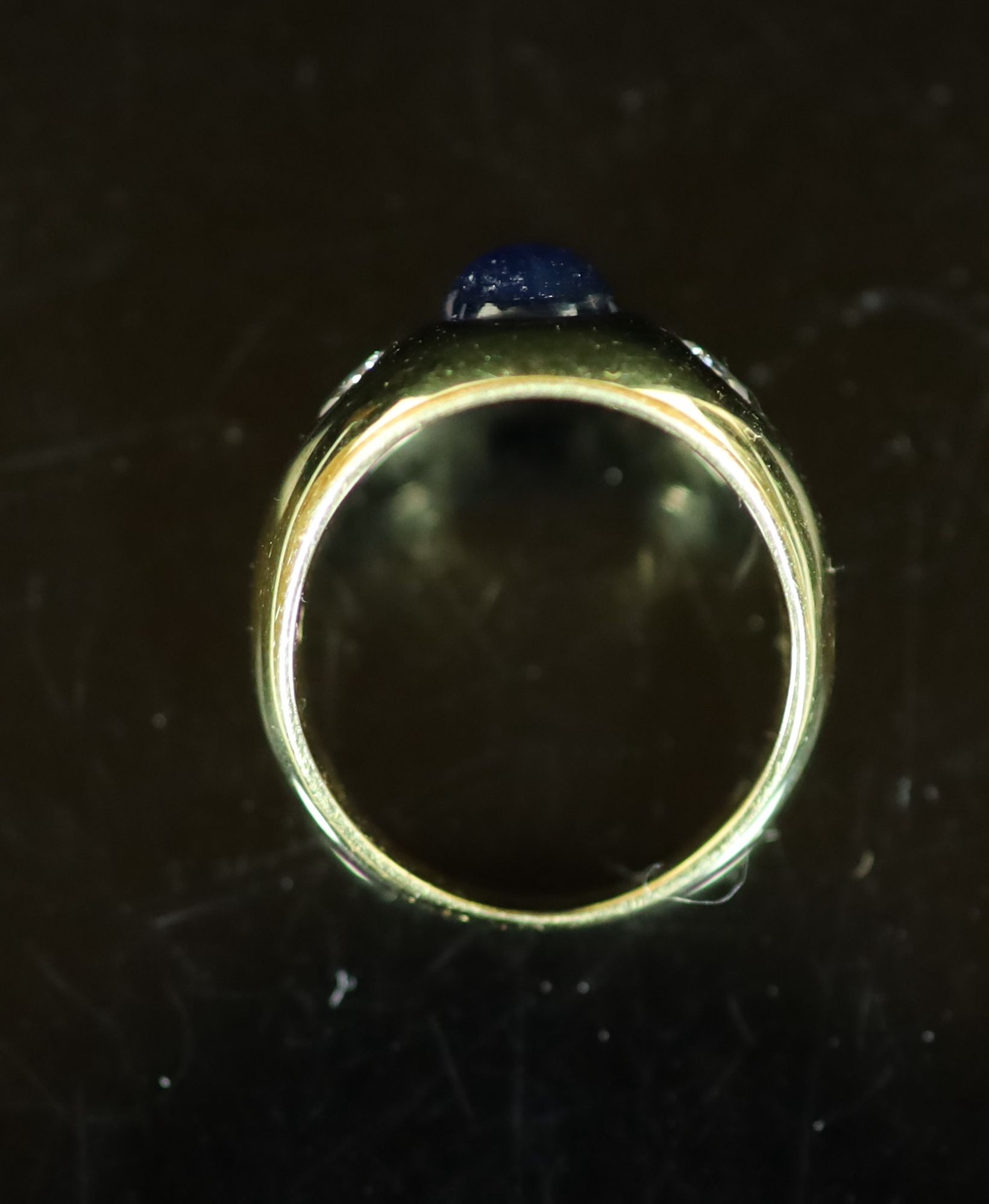 A Cartier 18ct gold , gypsy set cabochon sapphire and two stone diamond ring